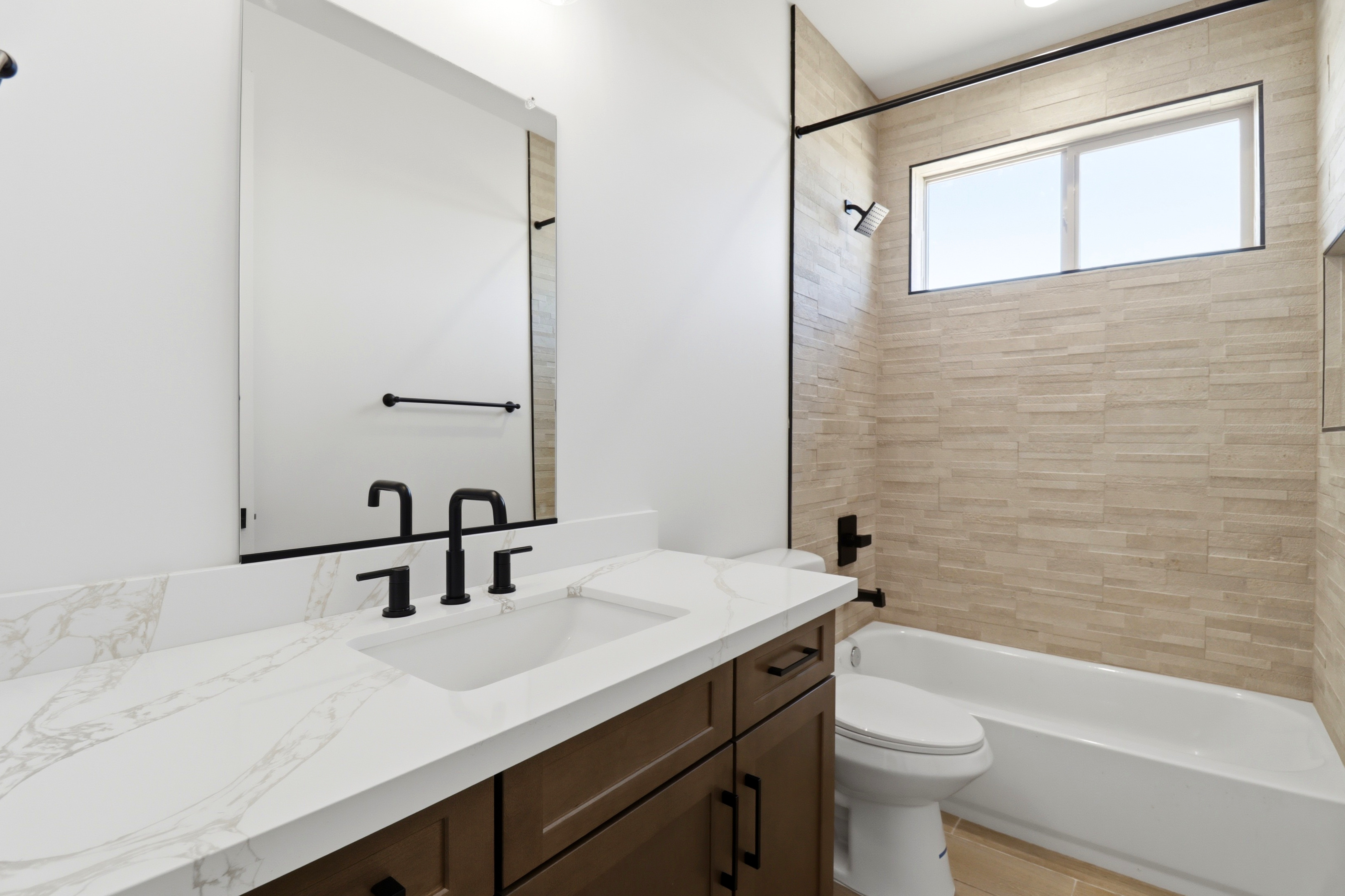 Luxury bathroom with quartz countertop and designer tile in a completed Jematell home in Surprise, AZ